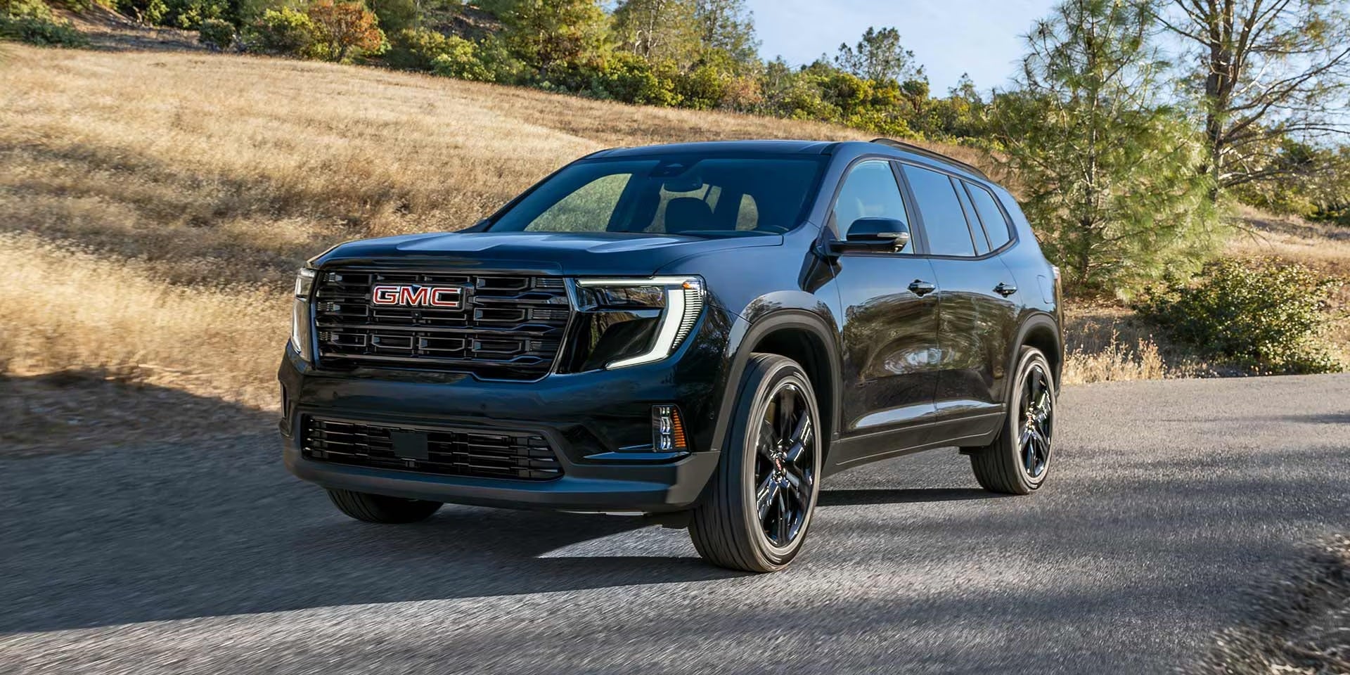 2026 GMC Acadia driving in Dover